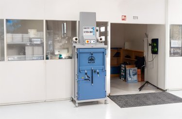 Pressa E119 posizionata lungo una parete con finestre