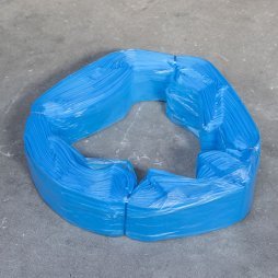 Fascio di sacchetti in plastica blu di grandi dimensioni (XL), disposti a forma di anello su una superficie grigia